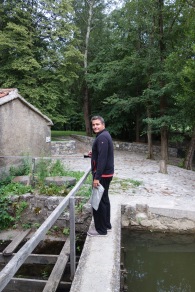 Skocjan, Slovenia: Walking across a dam over a creek at our campsite, to the firepit.