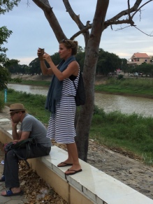 Jenny taking pictures of an instense hacky-sacker by the river in Battambang.